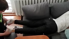 Young guy pays out his bills with his feet