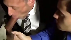 Bald bearded stud sucking four cocks in an orgy